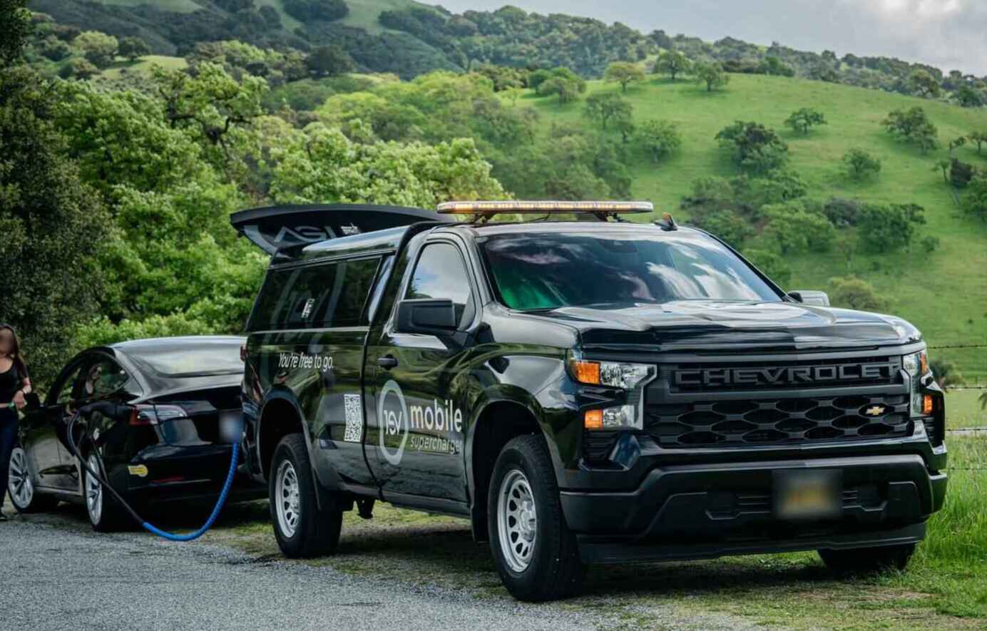 1EV Mobile Supercharger truck charging a Tesla